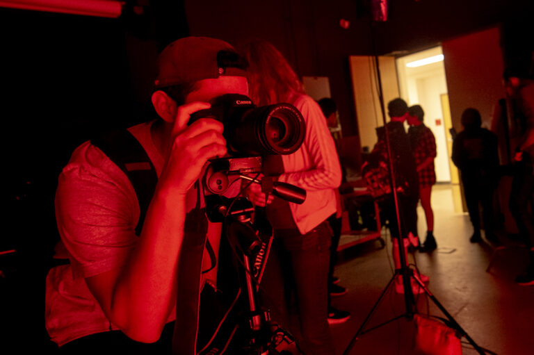 Students participating in a lighting demo inside the photo studio.